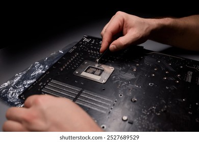Closeup of hands assembling computer parts, highlighting the precision and focus needed in technical work