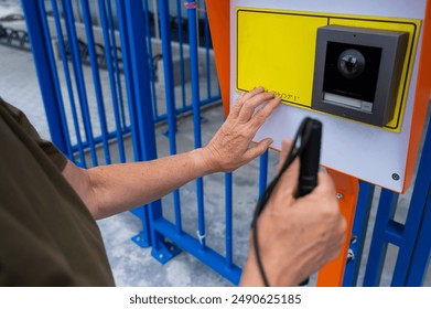 Close-up of the hands of a blind elderly woman reading a text in braille. Button for calling help for people with disabilities.  - Powered by Shutterstock