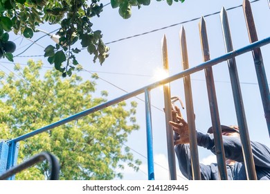 Closeup Of The Hands Of A Blue Collar Worker From Latin America Welding A Metal Fence