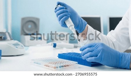 Close-up of hands in blue gloves using an electronic tube shaker for sample collection, with laboratory equipment.