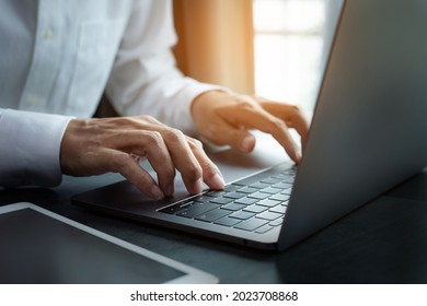 closeup hands of businessman working at office, Man typing keyboard on laptop or computer