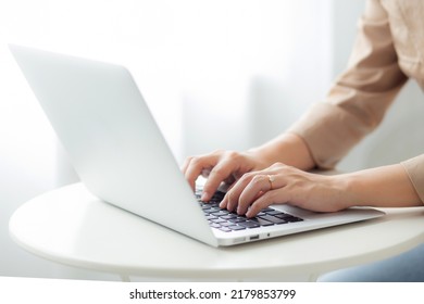 Closeup hands of businesswoman working on laptop computer on desk at home office, freelance looking and typing on notebook on table, lifestyles of woman studying online, business concept. - Shutterstock ID 2179853799