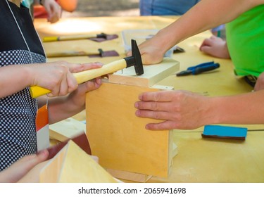 Close-up Of The Hands Of A Child Suffering From A Hammer Birdhouse