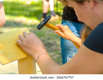 Close-up Of The Hands Of A Child Suffering From A Hammer Birdhouse