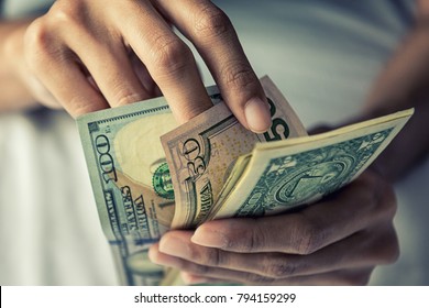 Close-up Hands counting money American dollars , Counting money American dollars with hand , Vintage tone effect , Income and Business concept. - Shutterstock ID 794159299