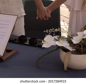 Close-up Of The Hands Of A Couple Entwined On Their Wedding Day Outdoors