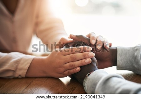 Closeup of hands of couple holding in loving support of care and comfort after grieving loss. Kind friends express sympathy and trust for each other in sweet and caring gesture together