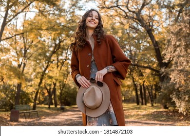 close-up hands details of attractive stylish woman holding hat and sunglasses walking in park dressed in warm coat autumn trendy street fashion style accessories - Shutterstock ID 1814872103