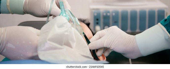 Closeup hands of doctor and assistant holding oxygen mask with patient emergency in the operation room at hospital, surgeon healing and surgery, problem of breathing, instruments medical and health. - Shutterstock ID 2146910545