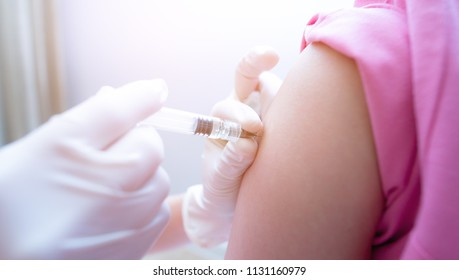 Close-up hand's doctor or nurses are vaccination to patient using the syringe injected upper arm for treated,Doctor giving an injection to a patient,Prophylactic HPV vaccination and anal cancer,