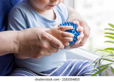 Closeup hands of father and baby boy toddler with prickly massage ball. Sensory or tactile activities. Children health. Massage textured balls for kids. Earlier development. Focus picked. - Shutterstock ID 2181054853