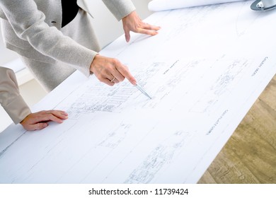 Close-up of hands of female architects working on blueprint. - Powered by Shutterstock