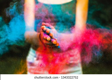 Closeup of Hands of a Girl who is clapping with colours during the celebration of Holi-festival of colours