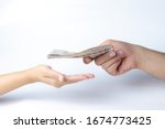 Closeup hands giving money isolated on white background.