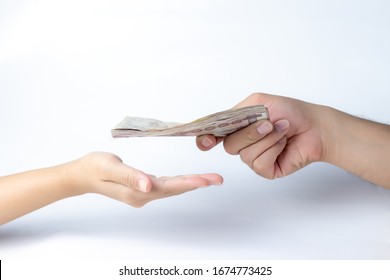 Closeup Hands Giving Money Isolated On White Background.