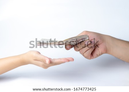 Closeup hands giving money isolated on white background.