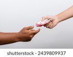 Closeup of hands giving rupiah money isolated on white background. Rupiah Indonesian money pay salaries concept.