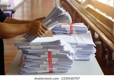 Closeup hands hold stack of used paper, combine to use next time or take to recycle process. Concept, eco friendly activity. Waste paper management. Reduce reuse, recycle paper.                       