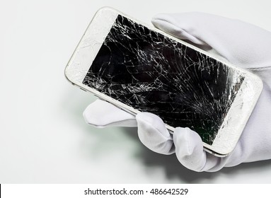 Close-up  Hands holding broken mobile smartphone.mobile smartphone LCD fracture.photos showing process of mobile phone repair, changing the screen.