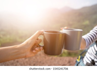 Closeup Hands Holding Coffee Cup Drinking Coffee Or Tea And Nature Background.Hands Clink Hot Coffee Mug Outdoor In The Morning , Friends Enjoy Drinking Together Cheers For Two Cup In Morning