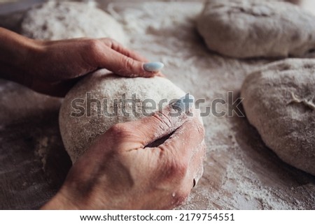 Close-up of hands holding dough . Baking chiabatta or pizza. Home made bread. Home bakery