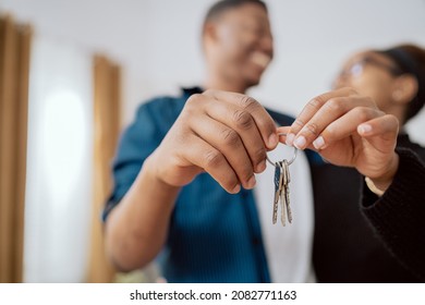 Close-up of hands holding keys to an apartment, married couple buying, renting a new apartment, the beginning of their journey together, real estate industry, investment