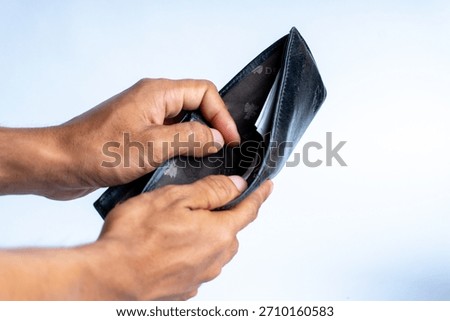 Close-up of hands holding an open empty wallet, symbolizing financial hardship, budgeting issues, poverty, or economic struggle. Ideal for finance-related themes.