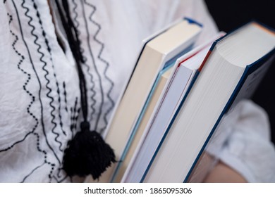 Closeup of Hands Holding A Stack Of Books. Concept of self-education, self-development