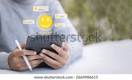 Close-up of hands holding a tablet with virtual customer review interface showing smiley icons and star ratings, concept of online feedback, user satisfaction, and business reputation management.