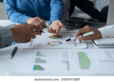 close-up hands image, Professional Asian male and female financial consultant or analyst working with them team, brainstorming and analyzing financial data on the report together in the office - Powered by Shutterstock