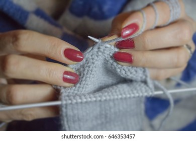 Close-up of hands knitting. Detail of the hands of an crocheting. Woman knitting small socks