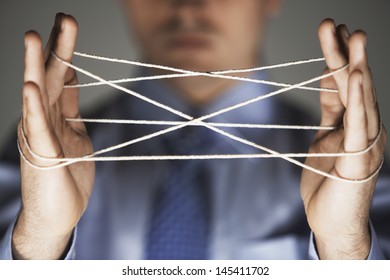 Closeup Of Hands Making Cat's Cradle