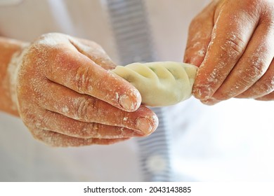 Close-up Of Hands Making Dumplings