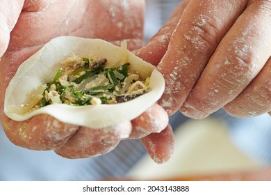 Close-up Of Hands Making Dumplings