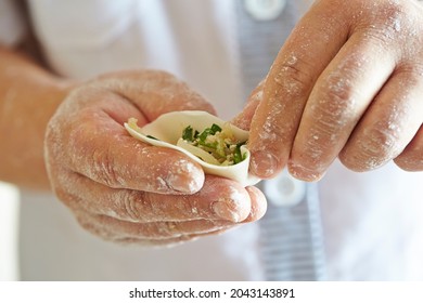 Close-up Of Hands Making Dumplings