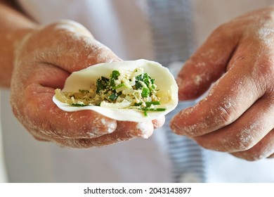 Close-up Of Hands Making Dumplings