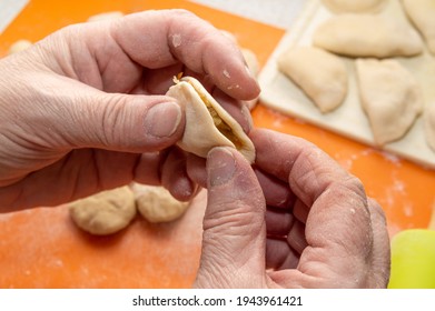 Close-up Of Hands Making Dumplings. High Quality Photo