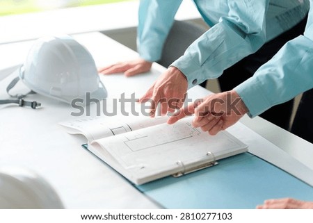 Close-up of the hands of a man in work clothes during a meeting