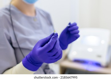 Close-up Of The Hands Of The Master Of Electrolysis In Which He Holds A Needle To Remove Unwanted Hair