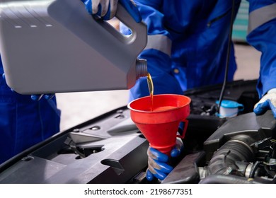 Closeup Hands Of Mechanic Man Pouring Motor Oil In Engine Car In The Garage, Automobile Change Lubricant Or Diesel, Worker Refilling Fluid At Auto Service, One Person, Vehicle And Transportation.