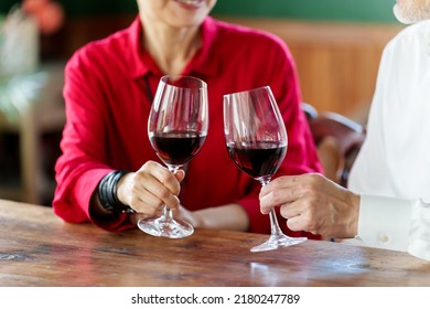 Closeup Hands Of Middle Aged Asian Couple Toasting With Red Wine