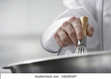 Closeup Of Hands Mixing Ingredients In A Bowl