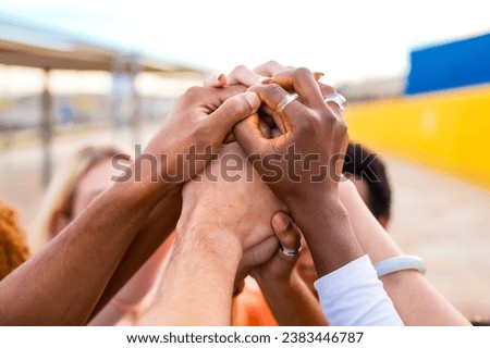 Close-up of hands of multi-ethnic people joining in the air