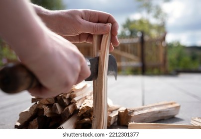 Close-up Of Hands And An Old, Rusty Knife Chopping Wood For Lighting The Fireplace