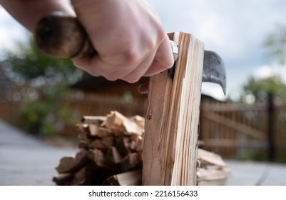 Close-up Of Hands And An Old, Rusty Knife Chopping Wood For Lighting The Fireplace