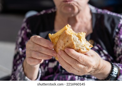 Close-up, Hands Of An Older Woman With A Sandwich.