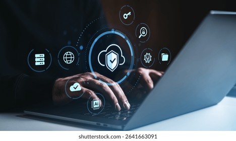 Close-up of hands on laptop keyboard with cloud storage and cybersecurity icons glowing on dark background, concept of secure online data access