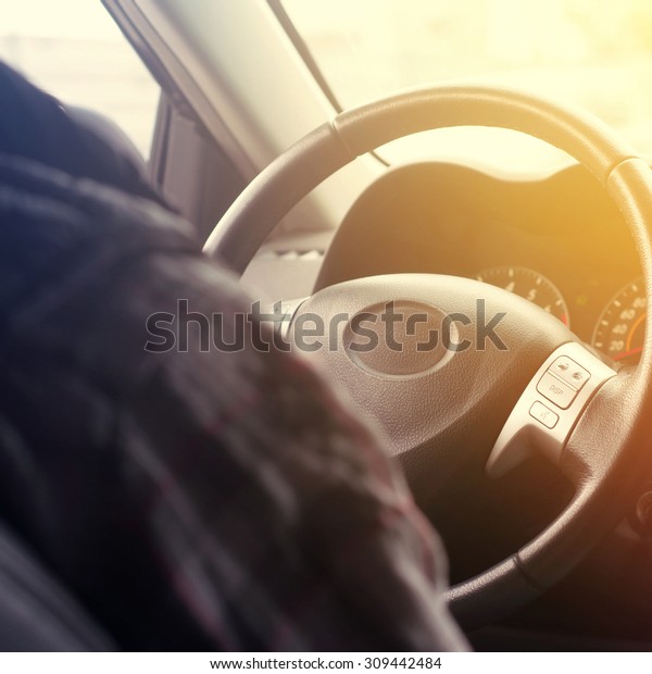 Close-up of hands on a\
steering wheel