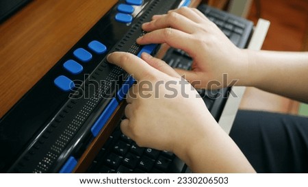 Close-up hands of person with blindness disability using computer with braille display or braille terminal a technology assistive device for persons with visual impairment