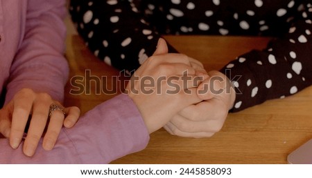 Close-up hands of a person experiencing difficulties touching the hands of a supportive individual, symbolizing empathy, compassion, understanding, and emotional support.